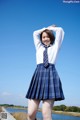 A woman in a school uniform posing for a picture.