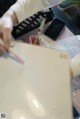 A person sitting at a desk writing on a piece of paper.